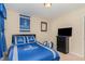 Bedroom showcasing Duke-themed decor, including bedding and wall hangings, plus dark wooden dresser at 2112 Ballston Pl, Knightdale, NC 27545