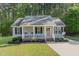 Charming single-story home with a cozy front porch and well-maintained landscaping at 2112 Ballston Pl, Knightdale, NC 27545