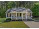 Charming single-story home with a cozy front porch and well-maintained landscaping at 2112 Ballston Pl, Knightdale, NC 27545
