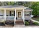 Charming front porch with rocking chairs, decorative accents, and a welcoming entrance at 2112 Ballston Pl, Knightdale, NC 27545