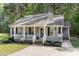 Inviting front porch with a seating area and a decorative wreath on the front door at 2112 Ballston Pl, Knightdale, NC 27545