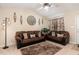 Inviting living room with matching sofas, ceiling fan, neutral colors, and natural lighting at 2112 Ballston Pl, Knightdale, NC 27545