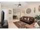 Cozy living room featuring comfortable sofas, a ceiling fan, and stylish decor at 2112 Ballston Pl, Knightdale, NC 27545