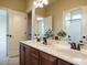 Bathroom showcasing double vanity with framed mirrors and neutral walls at 212 Listening Ridge Ln, Cary, NC 27519