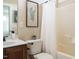 Bathroom featuring neutral walls, framed print, a vanity, and a shower/tub combo at 212 Listening Ridge Ln, Cary, NC 27519