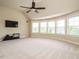 Bright bonus room with neutral walls, carpet, ceiling fan, and multiple windows at 212 Listening Ridge Ln, Cary, NC 27519
