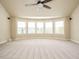 Bright bonus room with neutral walls, carpet, ceiling fan, and multiple windows at 212 Listening Ridge Ln, Cary, NC 27519