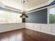 Bright dining area showcasing hardwood floors, custom trim work, and a stylish chandelier at 212 Listening Ridge Ln, Cary, NC 27519
