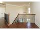 Elegant foyer with hardwood floors, staircase, and decorative lighting fixture at 212 Listening Ridge Ln, Cary, NC 27519