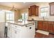 Open kitchen with an island, wood cabinets, stainless appliances and great natural light at 212 Listening Ridge Ln, Cary, NC 27519