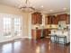 Open kitchen featuring an island with seating, stainless appliances, and seamless transition to outdoor patio at 212 Listening Ridge Ln, Cary, NC 27519