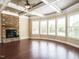 Bright living area with hardwood floors, a cozy fireplace, coffered ceilings, and ample windows at 212 Listening Ridge Ln, Cary, NC 27519