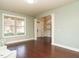 Bright living room with hardwood floors, fresh paint, natural light, and an open doorway at 212 Listening Ridge Ln, Cary, NC 27519