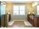 Beautiful main bathroom with dual vanities, granite countertops, and large window at 212 Listening Ridge Ln, Cary, NC 27519