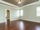 Spacious main bedroom with hardwood floors, tray ceiling, and natural light at 212 Listening Ridge Ln, Cary, NC 27519