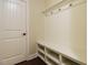 Organized mudroom with bench, storage cubbies, and coat hooks for convenience at 212 Listening Ridge Ln, Cary, NC 27519