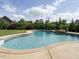 Beautiful backyard pool with a stone waterfall feature, surrounded by lush landscaping at 212 Listening Ridge Ln, Cary, NC 27519