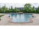 Gorgeous in-ground swimming pool with a rock waterfall and lush landscaping in a private backyard at 212 Listening Ridge Ln, Cary, NC 27519