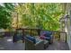 Relaxing back deck furnished with outdoor seating and views of lush greenery at 213 Beechtree Dr, Cary, NC 27513