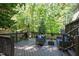 Wooden back deck featuring outdoor seating, landscaping, and string lights at 213 Beechtree Dr, Cary, NC 27513