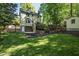 Spacious backyard featuring lush green lawn, storage shed, and climbing wall at 213 Beechtree Dr, Cary, NC 27513