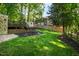 Lush backyard featuring a storage shed and a climbing wall at 213 Beechtree Dr, Cary, NC 27513