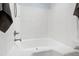 Shower-tub combo features sleek white walls and nickel-finished hardware at 213 Beechtree Dr, Cary, NC 27513