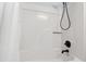 Shower-tub combo featuring sleek white walls and black hardware at 213 Beechtree Dr, Cary, NC 27513