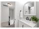 Powder room features a white vanity, white walls, black fixtures, and view of the stairs at 213 Beechtree Dr, Cary, NC 27513