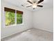 Bright bedroom features neutral carpet, white walls, and a window with natural lighting at 213 Beechtree Dr, Cary, NC 27513