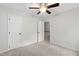 Spacious bedroom features neutral carpet, white walls, ceiling fan, and two white doors at 213 Beechtree Dr, Cary, NC 27513