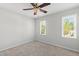 Bright bedroom with neutral carpet, ceiling fan, and sun-filled double windows at 213 Beechtree Dr, Cary, NC 27513