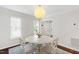 Dining room with white table and chairs, decorative rug, and natural light at 213 Beechtree Dr, Cary, NC 27513