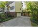 View of the home featuring a driveway, garage, and mature landscaping at 213 Beechtree Dr, Cary, NC 27513