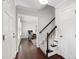 Inviting entryway featuring hardwood floors, staircase, and open doorway to living room at 213 Beechtree Dr, Cary, NC 27513