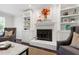 Fireplace with built-in shelving, hardwood floors, and comfortable seating at 213 Beechtree Dr, Cary, NC 27513