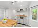 Open kitchen featuring white cabinets, an island with wood countertop, and breakfast nook at 213 Beechtree Dr, Cary, NC 27513