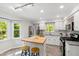 Bright kitchen featuring white cabinets, an island with wood countertop, and stainless steel appliances at 213 Beechtree Dr, Cary, NC 27513