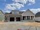 New two-story home with a two-car garage, covered porch, and neutral brown and gray color scheme at 2320 Eagle Shot Ct # 20, Fuquay Varina, NC 27526