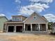 New two-story home with a two-car garage, covered porch, and neutral brown and gray color scheme at 2320 Eagle Shot Ct # 20, Fuquay Varina, NC 27526