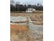A home foundation under construction with a gravel base in a treed lot at 2320 Eagle Shot Ct # 20, Fuquay Varina, NC 27526