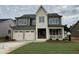 Charming two-story home boasts a two-car garage, covered porch, and lush green lawn at 2324 Eagle Shot Ct # 19, Fuquay Varina, NC 27526