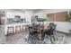 Bright dining area featuring a wood table, stylish rug, and seamless flow from kitchen with bar seating at 2736 Luxborough Ln, Mebane, NC 27302