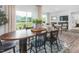 Bright dining area featuring a wood table that seamlessly flows into the living room with fireplace at 2736 Luxborough Ln, Mebane, NC 27302