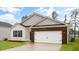 Charming single-Gathering home showcasing a brick and vinyl exterior with a two-car garage at 2736 Luxborough Ln, Mebane, NC 27302