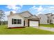 Beautiful single-Gathering home with brick accents, a two-car garage, and lush green lawn at 2736 Luxborough Ln, Mebane, NC 27302