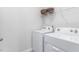 Well-lit laundry room with white washer and dryer units, plus a storage shelf at 2736 Luxborough Ln, Mebane, NC 27302