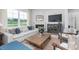 Inviting living room featuring a cozy sofa, fireplace, and large windows with natural light at 2736 Luxborough Ln, Mebane, NC 27302