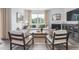 Inviting living room featuring a cozy sofa, fireplace, and large windows with natural light at 2736 Luxborough Ln, Mebane, NC 27302