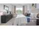 Serene main bedroom features a large window, neutral decor, and ensuite bathroom at 2736 Luxborough Ln, Mebane, NC 27302